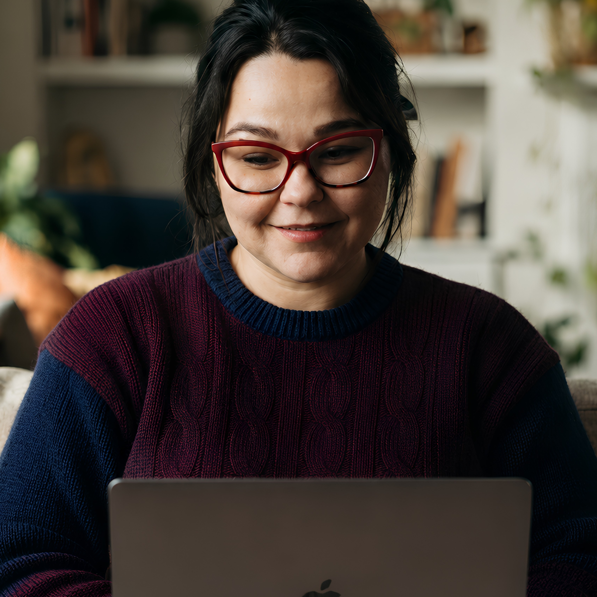 Nicole Phommanorat working on laptop, done for you business setup for solo creatives